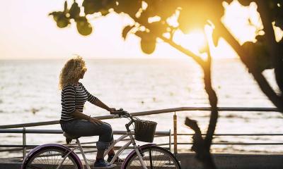 Lady Biking by a Lake